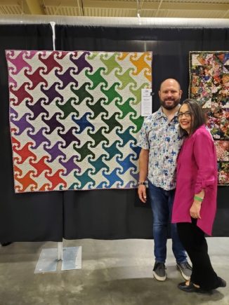 Owners Angie and DJ Lamoree with their Monkey Tails quilt